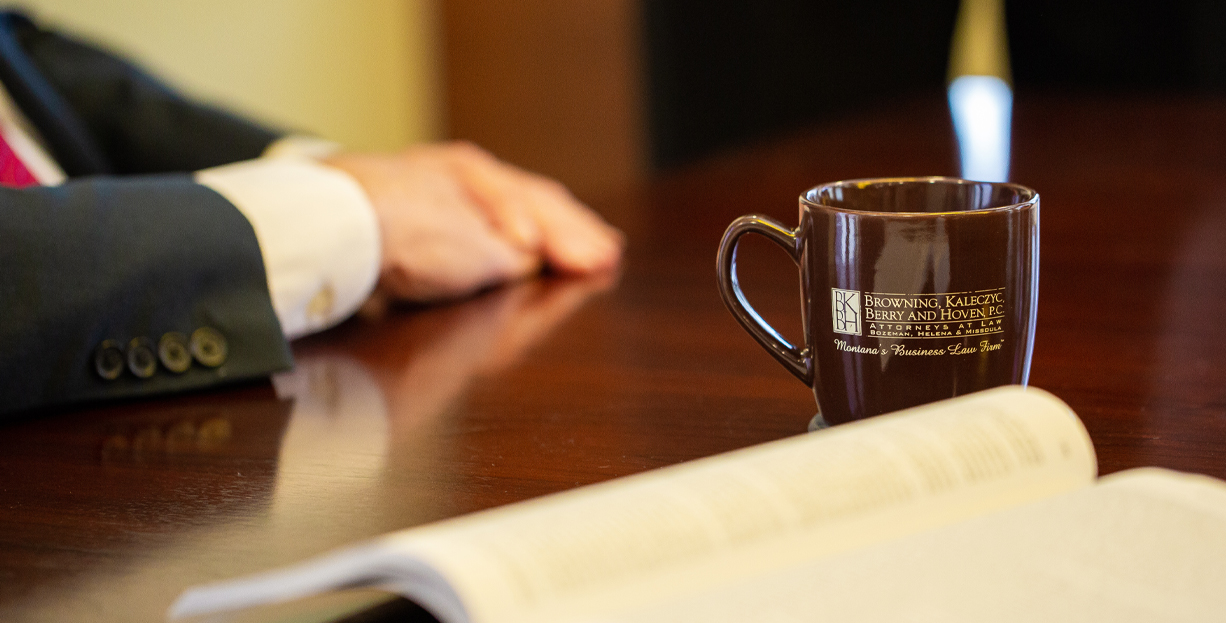 Coffee Cup and Open Book on Table